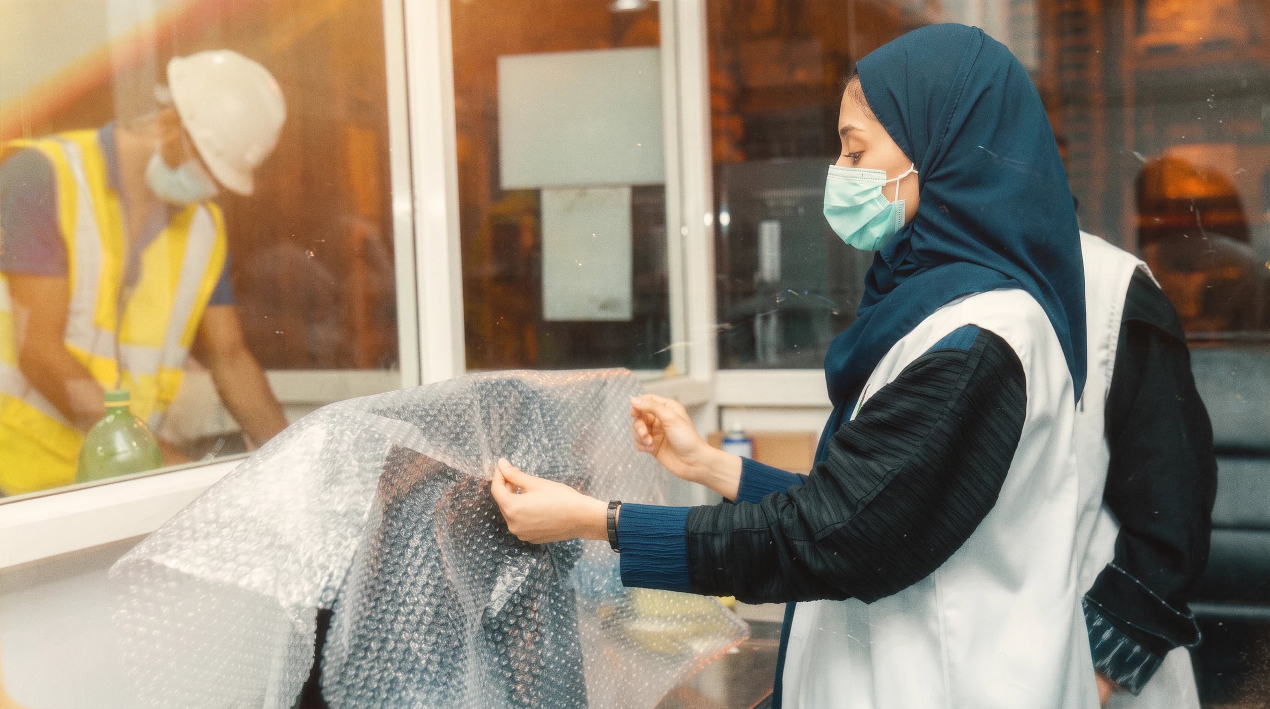 A volunteer wrapping a refurbished device